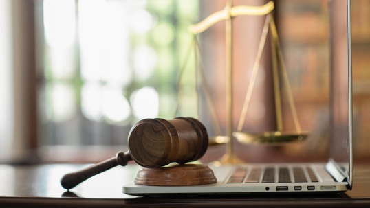gavel and laptop on desk
