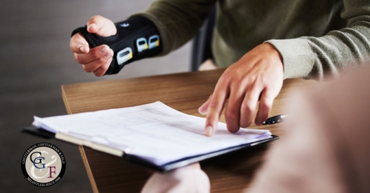 Injury, compensation and man hands with insurance documents, legal contract and paperwork. Disability, accident and people in lawyer or attorney meeting for advice, agreement or policy report closeup